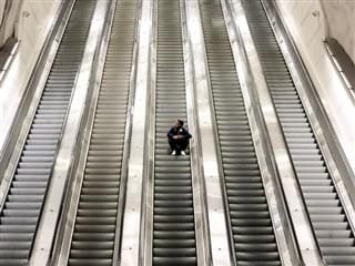 sitting on escalator steps