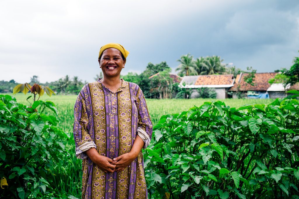 Woman smiling in Indonesian rice field