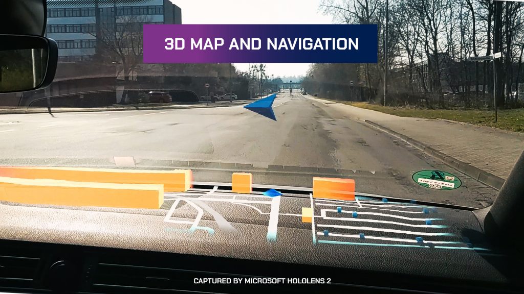 Photo taken inside a car showing navigational imagery superimposed on the windshield through the use of HoloLens.